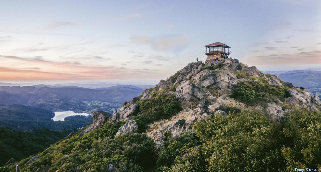The fire lookout on the East Peak of Mount Tamalpais at dusk, above the ridges and reservoirs of Marin County